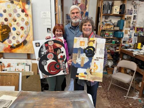 Three people standing in an art studio holding up their collage art